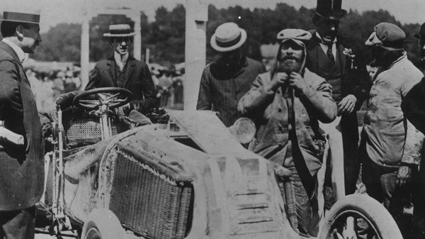 Black and White photo of people standing near the drive